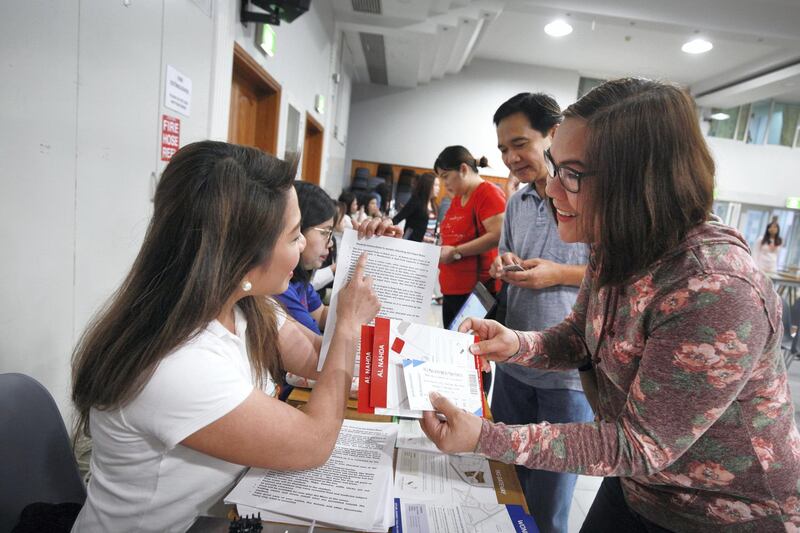 DUBAI, UNITED ARAB EMIRATES -Church volunteers are giving final instructions to those with tickets for the mass in Abu Dhabi at St. Mary's Catholic Church, Oud Mehta.  Leslie Pableo for The National for Anam Rizvi's story