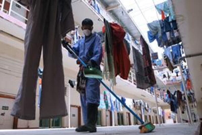 A worker sweeps the floor of one of the Arabtec labour camps in Jebel Ali.