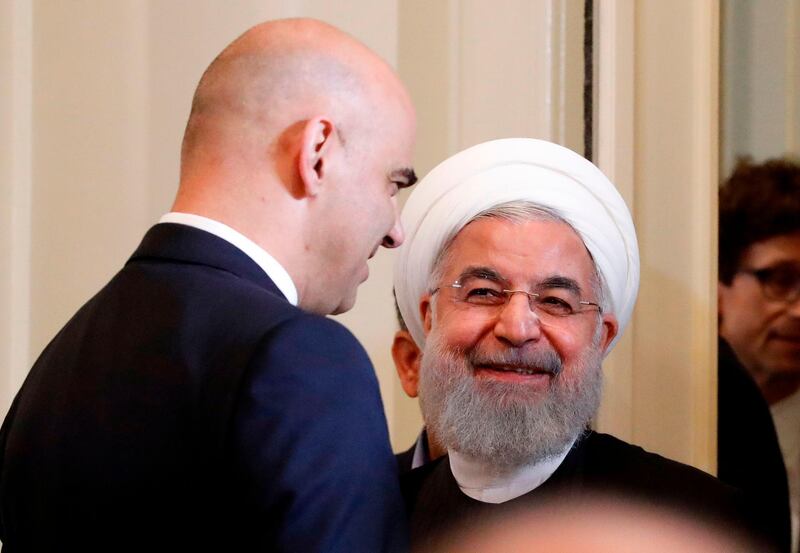 Iranian President Hassan Rouhani (R) and Swiss President Alain Berset share a light moment at a  joint press conference following various signing ceremonies in Bern on July 3, 2018. Rouhani is visiting Switzerland and Austria as part of a campaign by Tehran to secure continued European backing for the 2015 nuclear accord which is known as the Joint Comprehensive Plan of Action, substantial parts of which were negotiated in Switzerland.  / AFP / RUBEN SPRICH
