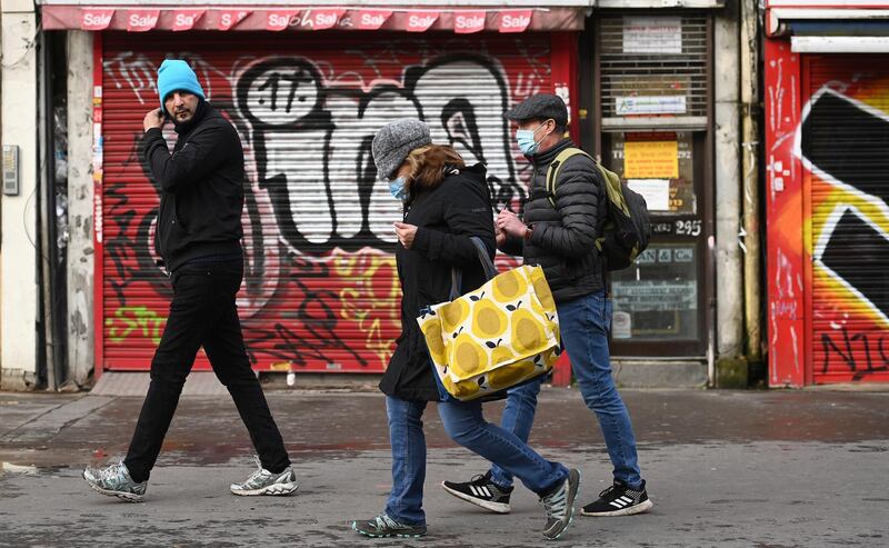 People walk past closed stores in London. EPA