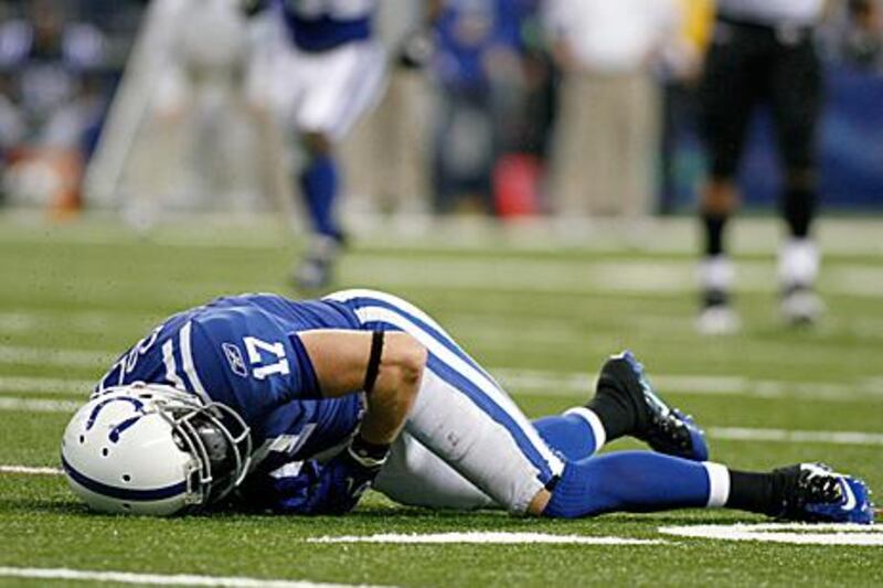 Austin Collie, the Colts' wide receiver, lies on the turf after a hit by the Jaguars resulted in his second concussion of the season.