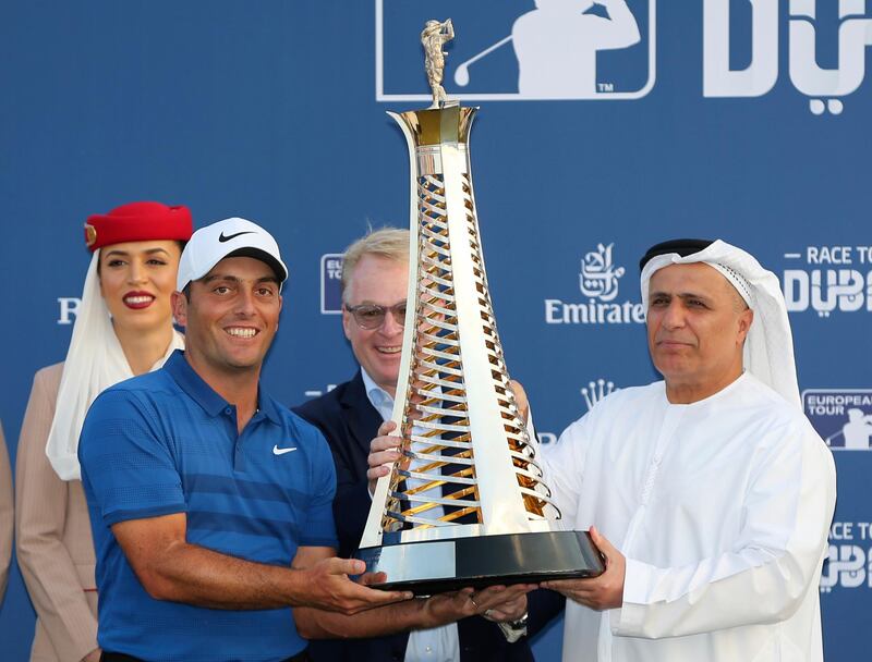 Italy's Francesco Molinari receives the Race to Dubai trophy from Mattar Al Tayer, Director General of the Roads and Transport Authority in Dubai, United Arab Emirates. AP Photo