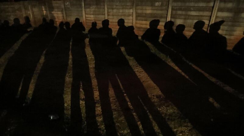 Shadows are cast as Zimbabwean voters queue to cast their ballots in the country's general elections in Harare, Zimbabwe. REUTERS / Mike Hutchings
