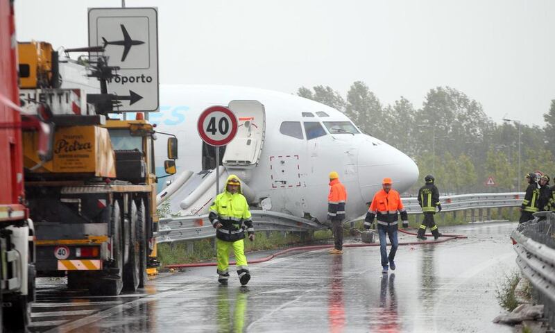 A DHL Boeing 737-400 cargo aircraft rests on a road after it overshot a runway after landing at Bergamo Orio al Serio airport in Italy. Matteo Bazzi / EPA