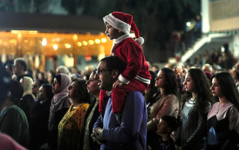 Palestinian Christians attend a Christmas tree lighting celebration on December 3, 2019 in Gaza City. / AFP / MAHMUD HAMS
