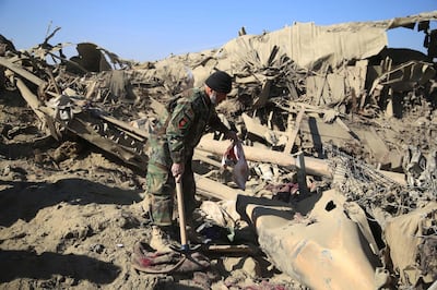 epa08975689 Afghan security official inspects the scene of a bomb blast that targeted Afghan National Army in Shirzad district of Nangarhar province, Afghanistan, 30 January 2021. At least eight members of the Afghan security forces were killed on 30 January, in a Taliban truck bombing against a checkpost in Shirzad district of the conflict-ridden eastern province of Nangarhar.  EPA/GHULAMULLAH HABIBI