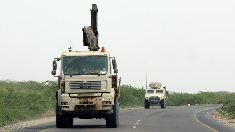 A truck crane and an armoured vehicle belonging to the Amalqa ("Giants") Brigades, loyal to the Saudi-backed government, drive along a road during the offensive to seize the Red Sea port city of Hodeidah from Iran-backed Houthi rebels, on its southern outskirts near the airport on June 21, 2018. Saleh Al-Obeidi / AFP