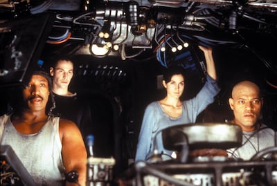 Publicity still of Keanu Reeves, Laurence Fishburne, Carrie-Anne Moss & Anthony Ray Parker in The Matrix. Courtesy Warner Bros. Pictures