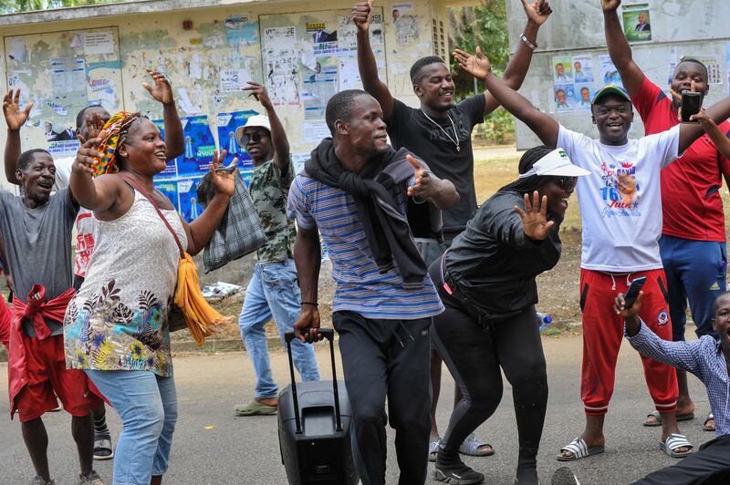 People celebrate in the streets of Akanda after the coup. EPA
