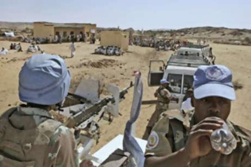 South African soldiers serving with the United Nations African Union Mission in Darfur patrol near the village of Kafod in North Darfur, Sudan.