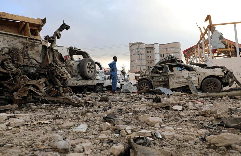 A security officer from Doorbin Hotel assesses the debris after a suicide car explosion in front of the hotel in Mogadishu, Somalia. Feisal Omar / Reuters