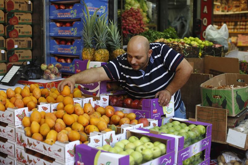 epa06171248 A Palestinian vendor arranges fruit on sale ahead of the Eid al-Adha festival, in the West Bank city of Nablus, 30 August 2017. Eid al-Adha is the holiest of the two Muslims holidays celebrated each year, it marks the yearly Muslim pilgrimage (Hajj) to visit Mecca, the holiest place in Islam. Muslims slaughter a sacrificial animal and split the meat into three parts, one for the family, one for friends and relatives, and one for the poor and needy.  EPA/ALAA BADARNEH