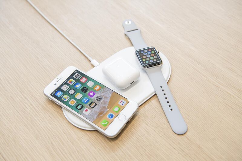 The Apple Inc. iPhone 8, Airpods, and Apple Watch sit on the AirPower charger during an event at the Steve Jobs Theater in Cupertino, California, U.S., on Tuesday, Sept. 12, 2017. Apple Inc. unveiled its most important new iPhone for years to take on growing competition from Samsung Electronics Co., Google and a host of Chinese smartphone makers. The device, coming a decade after the original model, is Apple's first major redesign since 2014 and represents a significant upgrade to the iPhone 7 line. Photographer: David Paul Morris/Bloomberg