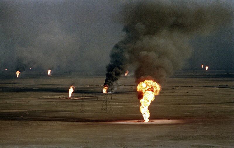 Aerial view dated 14 March 1991 of burning oil wells damaged by retreating Iraqi soldiers in Al-Ahmadi oil field in southern Kuwait. In 1991, Iraqi troops retreating after a seven-month occupation, smashed and torched 727 wells, badly polluting the atmosphere and creating crude oil lakes. In addition, up to eight billion barrels of oil were split into the sea by Iraqi forces damaging marine life and coastal areas up to 400 kilometres (250 miles) away. Kuwait will seek more than 16 billion dollars compensation for environment destruction brought by Iraq during the 1991 Gulf War, Kuwaiti newspaper Al-Anba said 07 December 1998. AFP PHOTO NICOLAS KAMM (Photo by NICHOLAS KAMM / AFP)