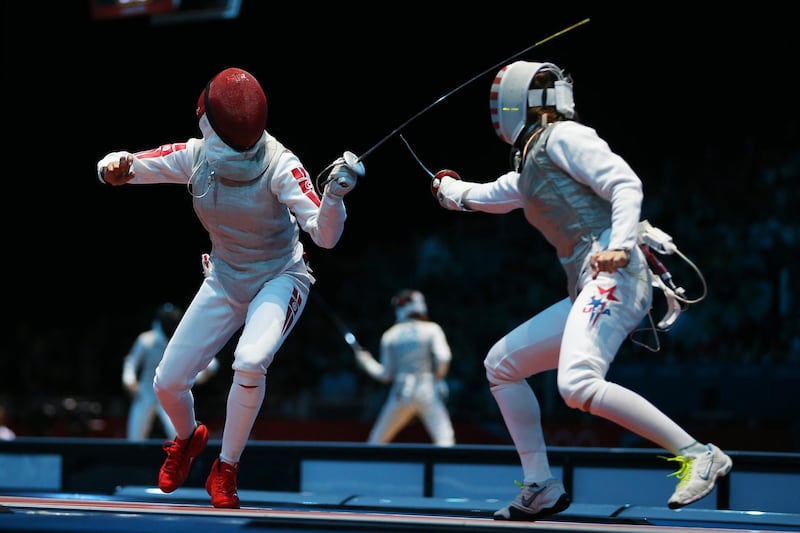 LONDON, ENGLAND - JULY 28:  Nicole Ross of the United States competes with Ines Boubakri of Tunisia in their Women's Foil Individual Fencing round of 32 match on Day 1 of the London 2012 Olympic Games at ExCeL on July 28, 2012 in London, England.  (Photo by Hannah Peters/Getty Images)