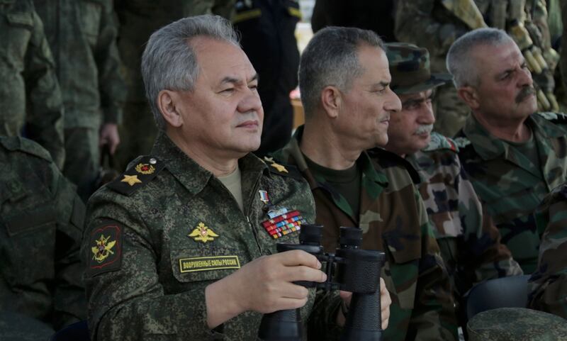 Russia's Defence Minister Sergey Shoigu, left, inspects Russian Navy drills in the Mediterranean Sea near Syria, on February 15. EPA