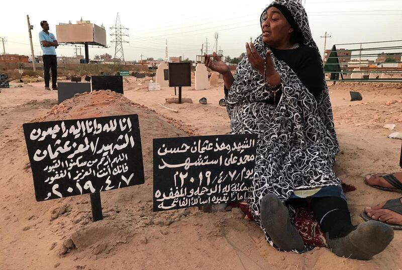 Khadom, the mother of Al Moez visits the tomb of her son, who was killed when a stray bullet pierced the window of his workplace during an anti-government demonstration in the Sudanese capital Khartoum.  AFP