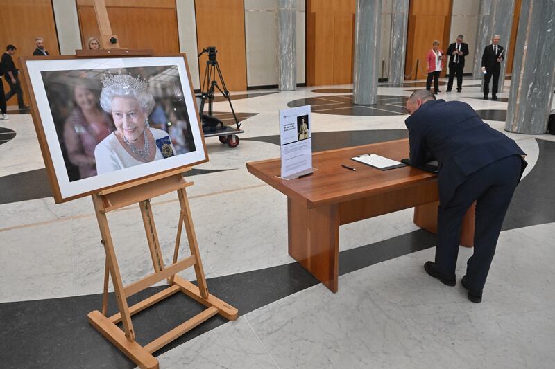 A member of the public signs the condolence book at Parliament House in Canberra, Australia. EPA