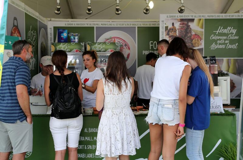 ABU DHABI , UNITED ARAB EMIRATES ,  November 9 , 2018 :- People ordering food at the Nolu���s  stall during the Taste of Abu Dhabi held at Du Arena on Yas Island in Abu Dhabi.  ( Pawan Singh / The National )  For News/Online/Instagram