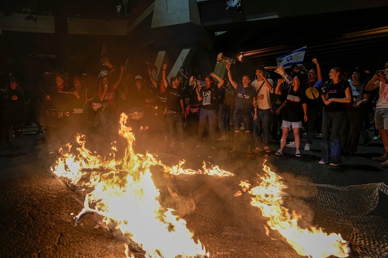 Demonstrators lit fires and raised anti-government slogans. AP