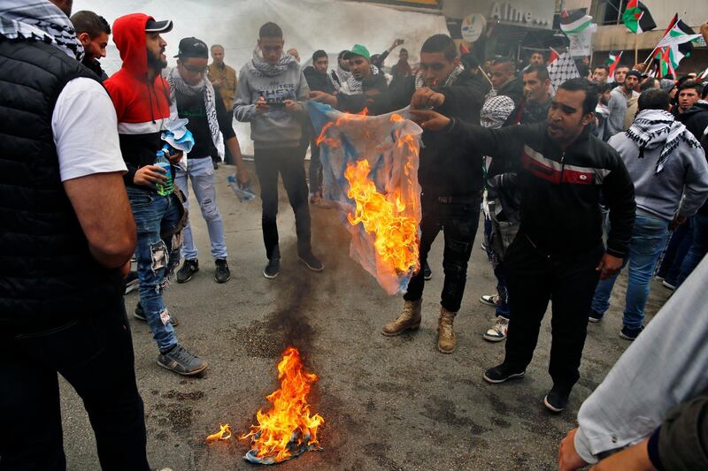 Protesters burn a mock Israeli flag in front of the US embassy in Awkar, Lebanon on December 10, 2017. Bilal Hussein / AP Photo