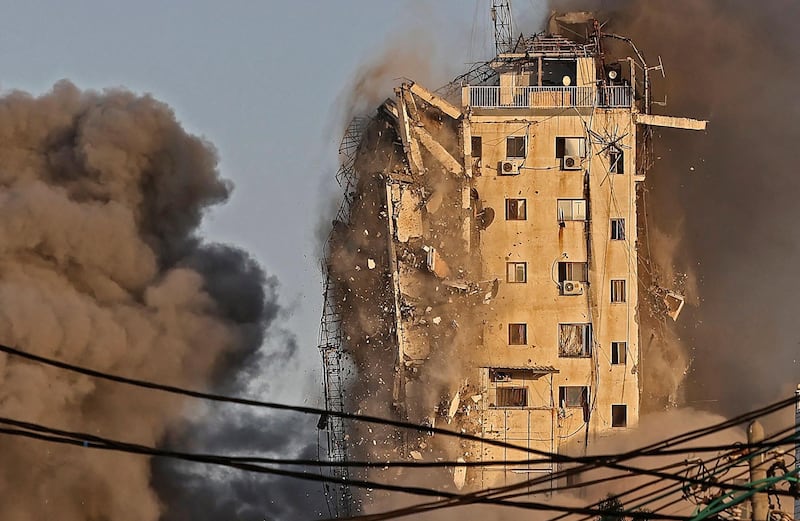 Al Sharouk tower block collapses after being hit by an Israeli air strike. AFP