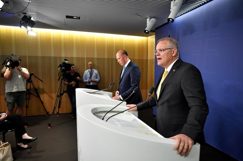 epa07182321 Australian Prime Minister Scott Morrison (R) speaks to the media alongside Minister for Home Affairs Peter Dutton (C) during a press conference in Sydney, Australia, 22 November 2018. Morrison will introduce new laws within weeks allowing the minister to strip citizenship from dual nationals convicted of terrorism, regardless of the length of their sentence.  EPA/JOEL CARRETT  AUSTRALIA AND NEW ZEALAND OUT