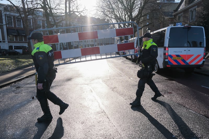 Police carry a security fence near the Peace Palace. AP