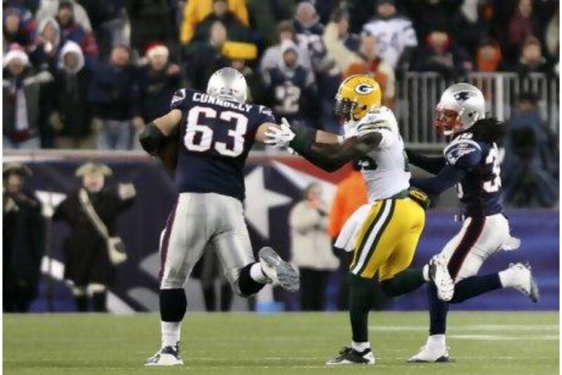 Dan Connolly, left, holds off Green Bay's Charlie Peprah on his way to a 71-yard run.