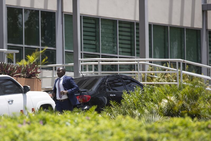 A security agent runs to the ministry building. EPA
