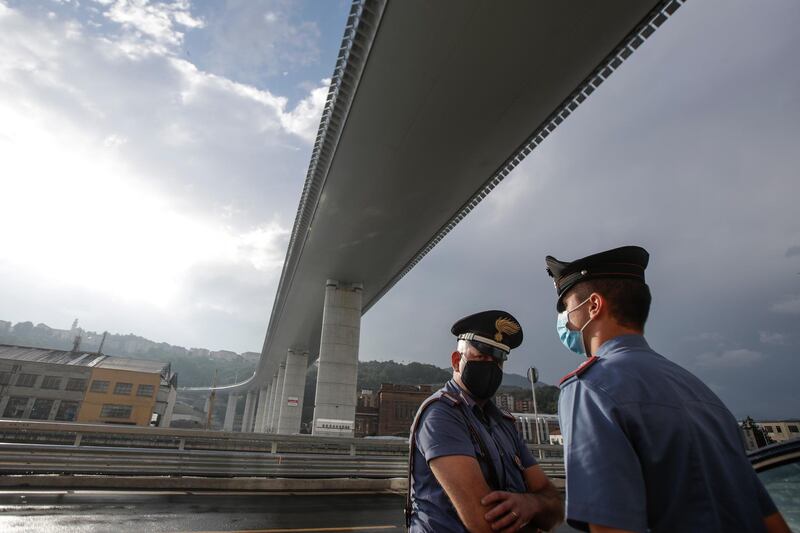Two Carabinieri officers stand under the new San Giorgio Bridge. AP