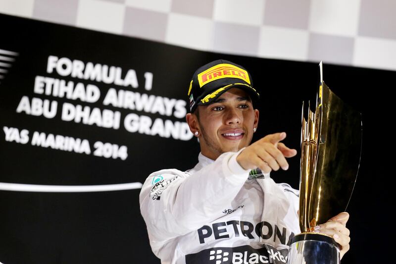 Abu Dhabi, United Arab Emirates, November 23, 2014:     Mercedes driver Lewis Hamilton celebrates racing to victory and the championship during the Formula One Etihad Airways Grand Prix at the Yas Marina Circuit in Abu Dhabi on November 23, 2014. Christopher Pike / The National

Reporter:  N/A
Section: Sport
Keywords: 

