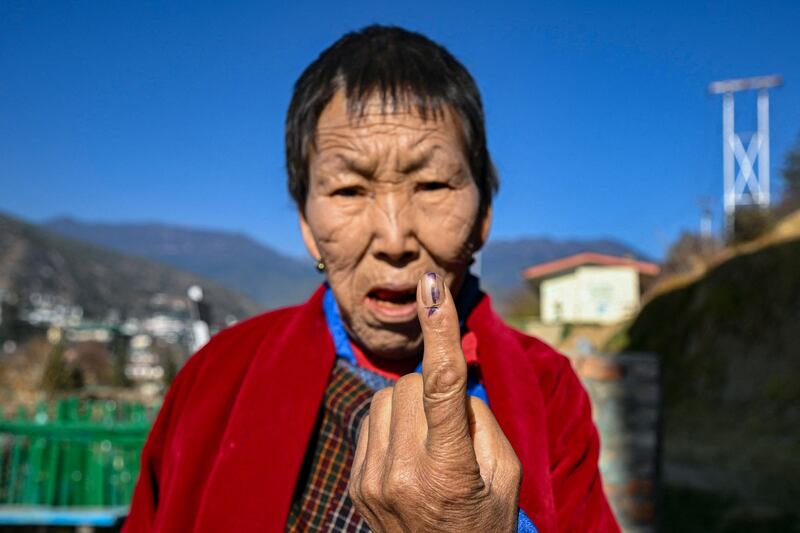 A voter shows the indelible ink mark after casting her vote at a polling station during general elections in Thimphu, Bhutan. AFP