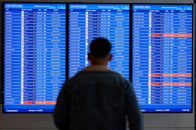 A traveller looks at a flight board with delays and cancellations at Ronald Reagan Washington National Airport in Arlington. Thousands of travellers were stranded at US airports after an hours-long computer outage. AP Photo 