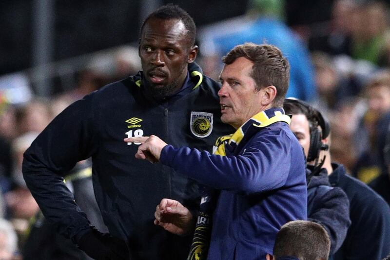 Usain Bolt receives instructions before making his first appearance for Central Coast Mariners. AFP