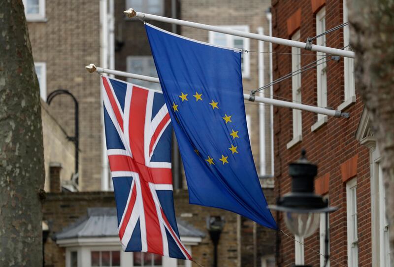 FILE - In this file photo dated Tuesday, March 14, 2017, a European flag flies along with a British Union flag, left, outside Europe House, the European Parliament's British offices, in London. As part of an improved offer announced Tuesday Nov. 7, 2017, before a new round of Brexit talks scheduled for later this week, Britain promised that European Union citizens will have the right to appeal if they are denied permission to stay in the country after it leaves the EU. (AP Photo/Matt Dunham, FILE)
