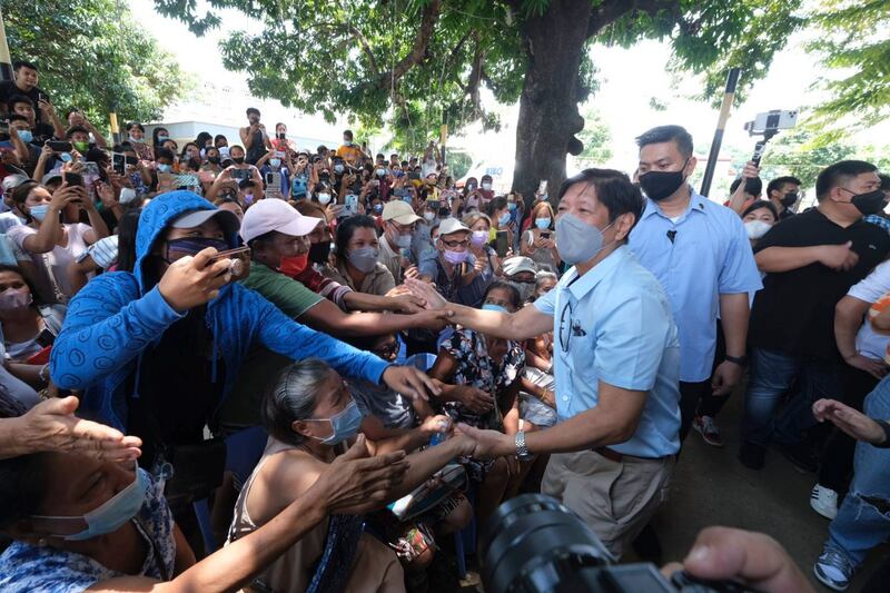 Philippine President Ferdinand Marcos Jr greets residents during his visit a day after a strong quake struck Bangued, Abra province, on July 28. AP Photo