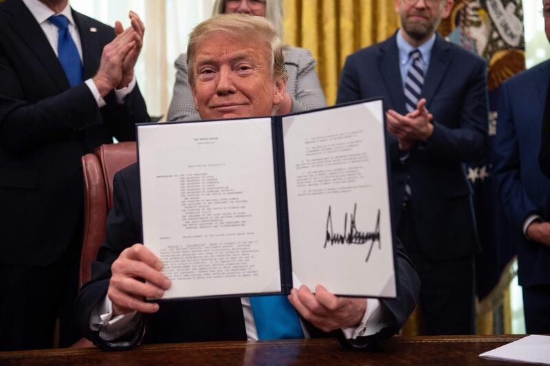 (FILES) In this file photo taken on February 19, 2019, US President Donald Trump shows his signature on the Space Policy Directive-4 (SPD-4) at the White House in Washington, DC. The US is getting a new space force along with $738 billion in military spending under an agreement backed by lawmakers on December 10, 2019, that fulfils a priority of President Donald Trump. The 2020 spending in the National Defense Authorization Act is a jump from the $716 billion authorized last year, and will go to pay for a wide range of military activities. It will also create a space-based sixth branch of the military -- a priority of Trump's -- after the army, air force, navy, Marine Corps and coast guard. / AFP / NICHOLAS KAMM
