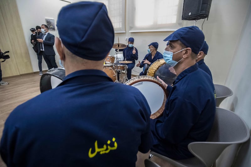 Inmates perform in a band.