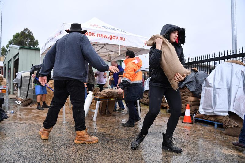 Volunteers at Penrith State Emergency Service making and distributing free sandbags to residents in Sydney. EPA