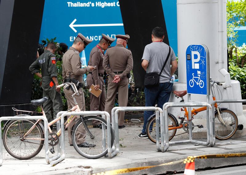 Members of the Explosive Ordnance Disposal (EOD) squad and Thai forensic police officers inspect the area where a small bomb exploded in Bangkok, Thailand.  EPA