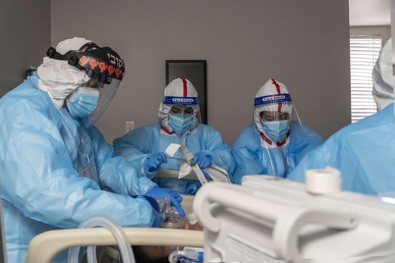 Doctor Joseph Varon (L) and other medical staff members perform an intubation procedure on a patient in the Covid-19 intensive care unit at the United Memorial Medical Center in Houston, Texas. AFP