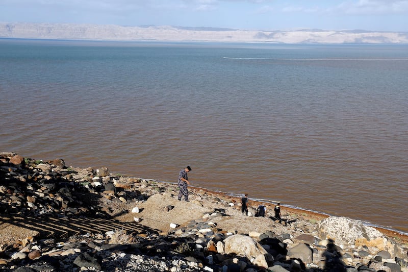 A rescuer walks along the shoreline of the Dead Sea in Jordan as the country's civil defence searches for survivors after flash flooding swept away a class on a school trip. Reuters