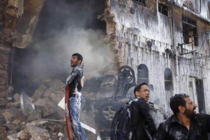 A fireman reacts as he works at the site of a military aircraft crash in Sanaa that killed at least 11 people on Tuesday. Khaled Abdullah / Reuters