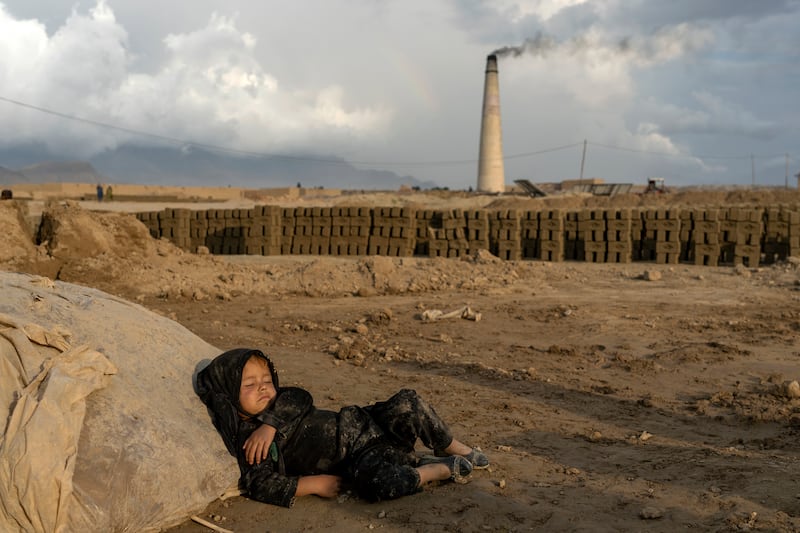 The landscape around the factories is bleak and barren, with the kilns’ smokestacks pumping out black, sooty smoke. Families live in dilapidated mud houses next to furnaces, each with a corner where they make their bricks. For most, a day’s meal is bread soaked in tea.