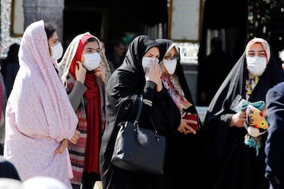 epa08233804 Iranian women wearing face masks wait in line at a polling station set up at the Abdol Azim shrine during the parliamentary elections in Shahr-e-Ray, Tehran Province, Iran, 21 February 2020. Iranians are heading to the polls to elect their representatives to the Islamic Consultative Assembly amid a worsening economic crisis and escalating tensions with the US.  EPA/ABEDIN TAHERKENAREH