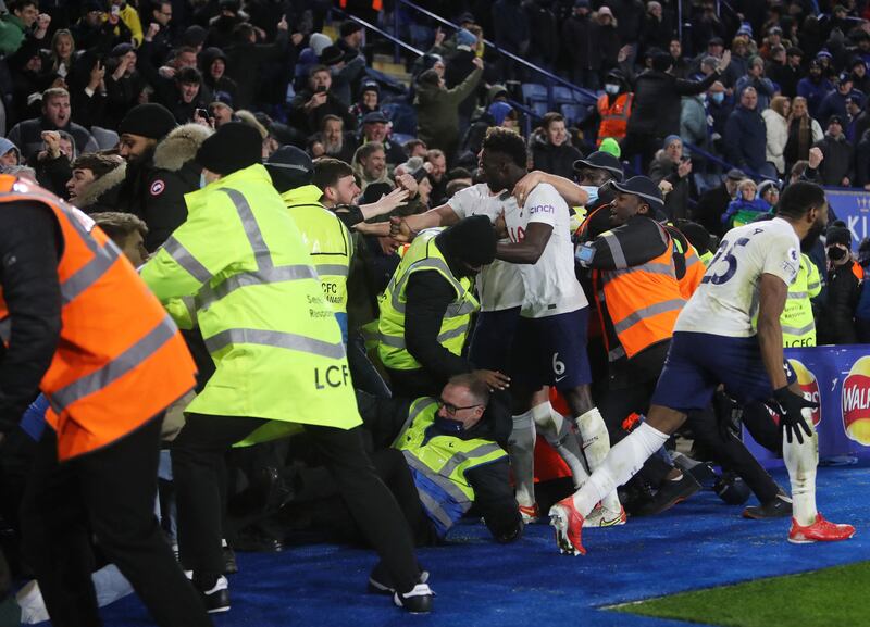Tottenham players celebrate with fans in the stands after Steven Bergwijn scores the late winning goal against Leicester. AFP