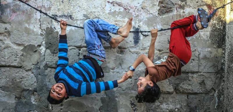 MAHMOUD ABU SALAMA LIFE GAZA - PALESTINE - JABALIYA REFUGEE CAMP
Children from Jabaliya Refugee Camp in Gaza. They play using this rope every Friday. It’s their way of having fun trying to enjoy life. Credit: National Geographic. 