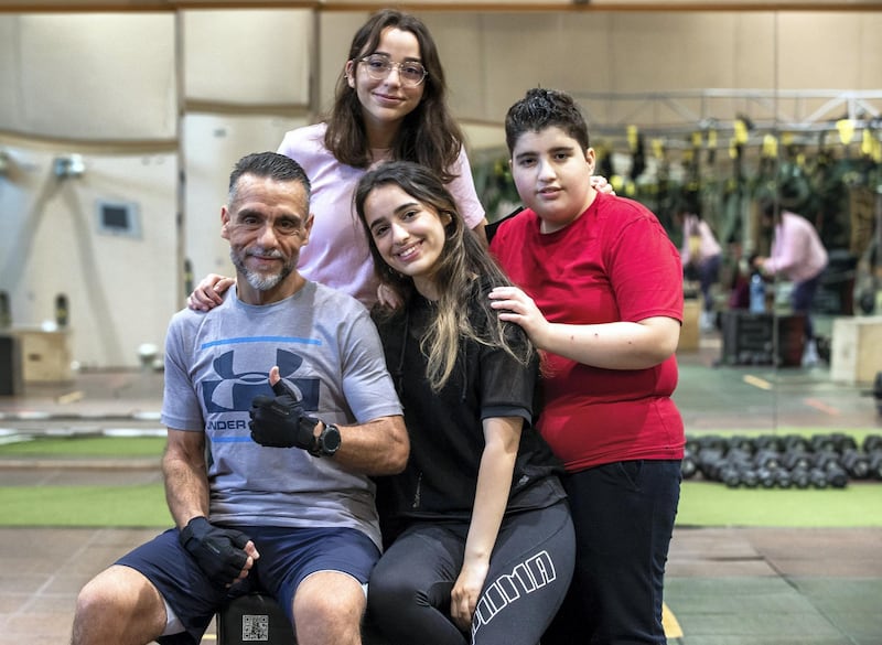 Ihsan Al Sakka does weight training and cardio excercises with his children, L-R) Huda-15, Nur-20 and Abdulvahab-14 at the Abu Dhabi Country Club on June 1st, 2021. Victor Besa / The National.
Reporter: Haneen Dajani for News