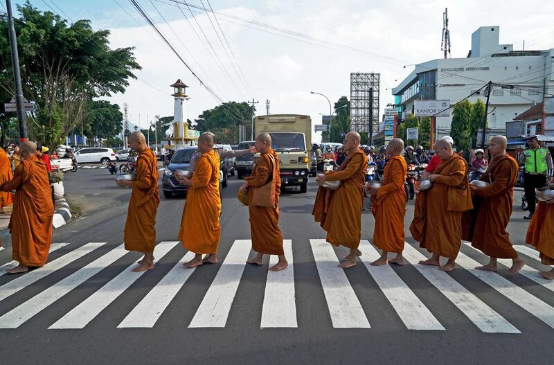 Buddhist monks collect alms one day before Vesak day in Magelang. Buddhists in Indonesia mark Vesak Day on May 29 to celebrate the birth, enlightenment and death of the Buddha. Rafi Akhdantyo / AFP